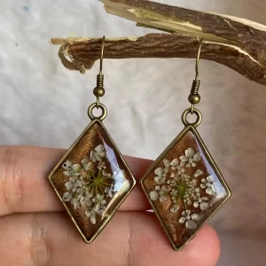 Handmade bronze resin earrings with real dried white flowers in diamond shape